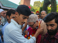 Jammu and Kashmir National Conference (JKNC) party leader Omar Abdullah (C) is greeted by supporters with garlands at his residence in Srina...