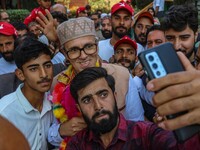 Supporters of the Jammu and Kashmir National Conference (JKNC) party take a selfie with party leader Omar Abdullah at his residence in Srina...