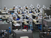 Workers make handmade dumplings in a workshop at a food factory in Suqian, China, on October 9, 2024. (