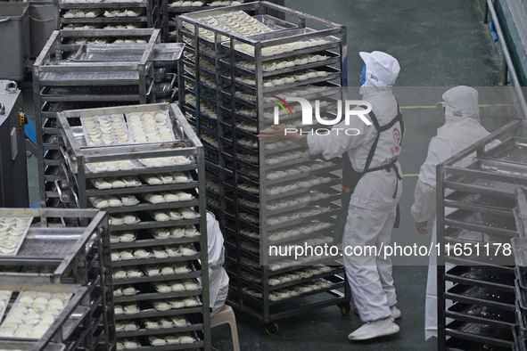 Workers make handmade dumplings in a workshop at a food factory in Suqian, China, on October 9, 2024. 