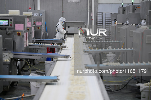 Workers make handmade dumplings in a workshop at a food factory in Suqian, China, on October 9, 2024. 