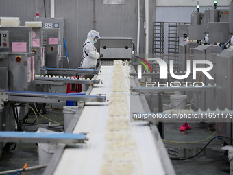 Workers make handmade dumplings in a workshop at a food factory in Suqian, China, on October 9, 2024. (