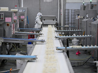 Workers make handmade dumplings in a workshop at a food factory in Suqian, China, on October 9, 2024. (