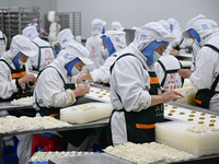 Workers make handmade dumplings in a workshop at a food factory in Suqian, China, on October 9, 2024. (