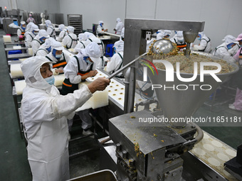 Workers make handmade dumplings in a workshop at a food factory in Suqian, China, on October 9, 2024. (