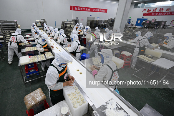 Workers make handmade dumplings in a workshop at a food factory in Suqian, China, on October 9, 2024. 