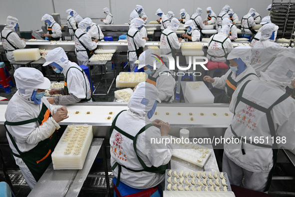 Workers make handmade dumplings in a workshop at a food factory in Suqian, China, on October 9, 2024. 