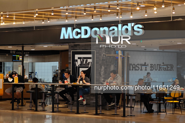 Customers eat at a McDonald's fast food restaurant in a shopping mall in the Huangpu district of Shanghai, China, on October 9, 2024. 