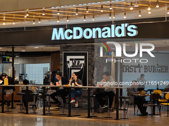 Customers eat at a McDonald's fast food restaurant in a shopping mall in the Huangpu district of Shanghai, China, on October 9, 2024. (