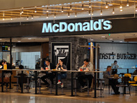 Customers eat at a McDonald's fast food restaurant in a shopping mall in the Huangpu district of Shanghai, China, on October 9, 2024. (