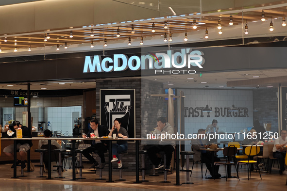 Customers eat at a McDonald's fast food restaurant in a shopping mall in the Huangpu district of Shanghai, China, on October 9, 2024. 