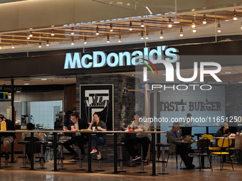 Customers eat at a McDonald's fast food restaurant in a shopping mall in the Huangpu district of Shanghai, China, on October 9, 2024. (