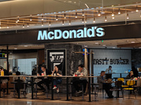 Customers eat at a McDonald's fast food restaurant in a shopping mall in the Huangpu district of Shanghai, China, on October 9, 2024. (