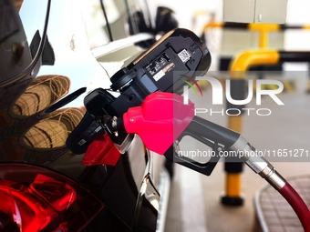 A vehicle fills up at a gas station in the Haidian district in Beijing, China, on October 9, 2024. (