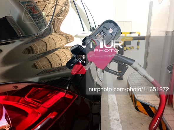 A vehicle fills up at a gas station in the Haidian district in Beijing, China, on October 9, 2024. 