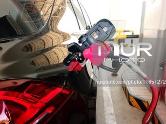 A vehicle fills up at a gas station in the Haidian district in Beijing, China, on October 9, 2024. (