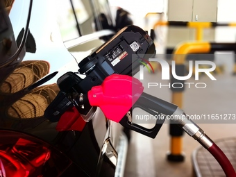 A vehicle fills up at a gas station in the Haidian district in Beijing, China, on October 9, 2024. (