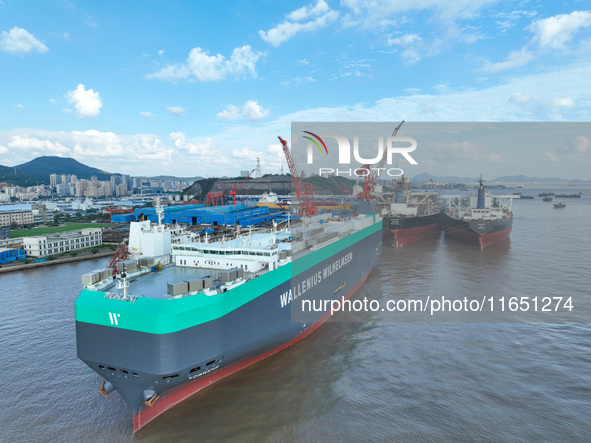 Workers at a ship maintenance company repair a ship in Zhoushan, China, on October 9, 2024. 