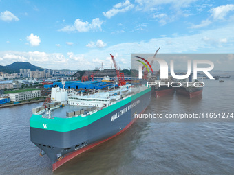 Workers at a ship maintenance company repair a ship in Zhoushan, China, on October 9, 2024. (