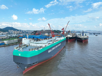 Workers at a ship maintenance company repair a ship in Zhoushan, China, on October 9, 2024. (