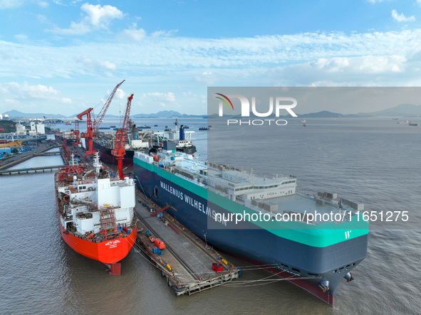 Workers at a ship maintenance company repair a ship in Zhoushan, China, on October 9, 2024. 