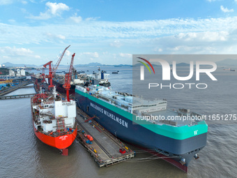 Workers at a ship maintenance company repair a ship in Zhoushan, China, on October 9, 2024. (