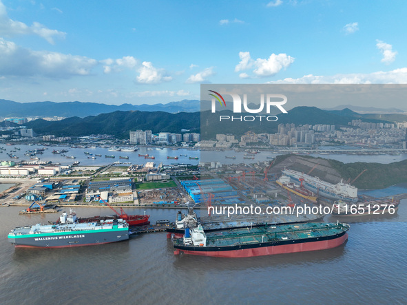 Workers at a ship maintenance company repair a ship in Zhoushan, China, on October 9, 2024. 