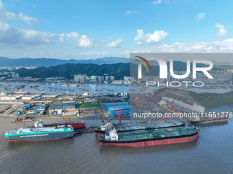 Workers at a ship maintenance company repair a ship in Zhoushan, China, on October 9, 2024. (