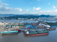 Workers at a ship maintenance company repair a ship in Zhoushan, China, on October 9, 2024. (