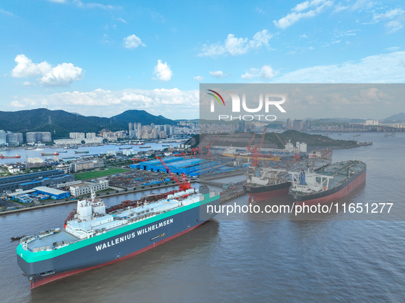 Workers at a ship maintenance company repair a ship in Zhoushan, China, on October 9, 2024. 