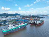 Workers at a ship maintenance company repair a ship in Zhoushan, China, on October 9, 2024. (