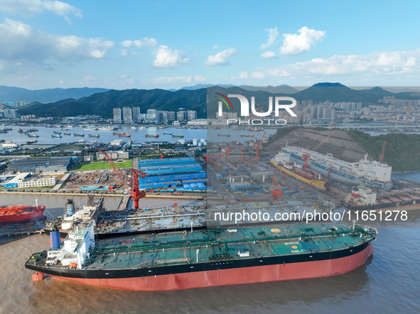 Workers at a ship maintenance company repair a ship in Zhoushan, China, on October 9, 2024. 