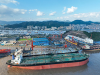 Workers at a ship maintenance company repair a ship in Zhoushan, China, on October 9, 2024. (