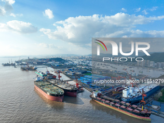 Workers at a ship maintenance company repair a ship in Zhoushan, China, on October 9, 2024. (