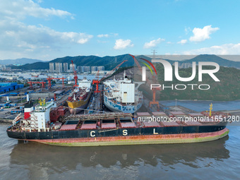 Workers at a ship maintenance company repair a ship in Zhoushan, China, on October 9, 2024. (