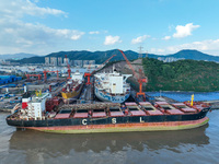 Workers at a ship maintenance company repair a ship in Zhoushan, China, on October 9, 2024. (