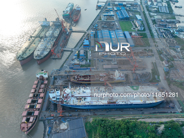 Workers at a ship maintenance company repair a ship in Zhoushan, China, on October 9, 2024. 