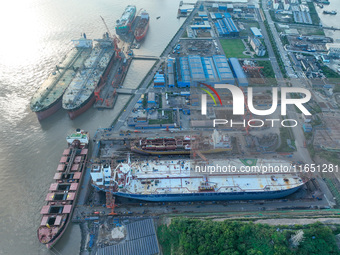 Workers at a ship maintenance company repair a ship in Zhoushan, China, on October 9, 2024. (