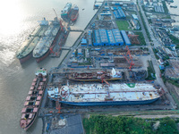 Workers at a ship maintenance company repair a ship in Zhoushan, China, on October 9, 2024. (