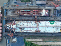 Workers at a ship maintenance company repair a ship in Zhoushan, China, on October 9, 2024. (