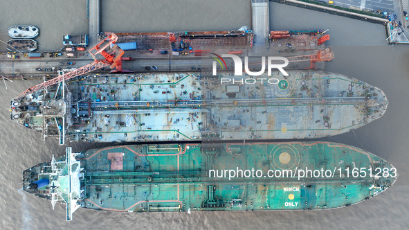 Workers at a ship maintenance company repair a ship in Zhoushan, China, on October 9, 2024. 