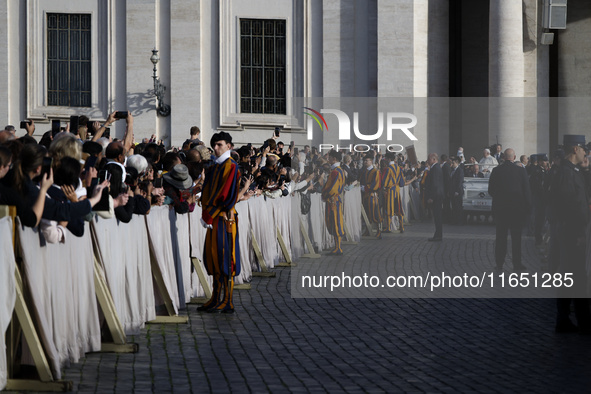 Pope Francis waves to the crowd from the popemobile as he arrives for the weekly general audience at St. Peter's Square in The Vatican on Oc...