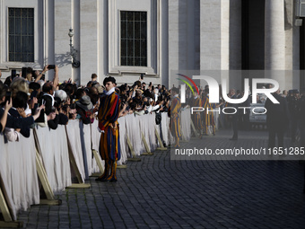 Pope Francis waves to the crowd from the popemobile as he arrives for the weekly general audience at St. Peter's Square in The Vatican on Oc...