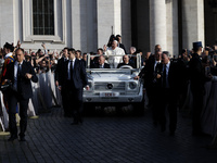 Pope Francis waves to the crowd from the popemobile as he arrives for the weekly general audience at St. Peter's Square in The Vatican on Oc...