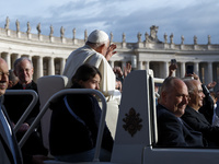 Pope Francis waves to the crowd from the popemobile as he arrives for the weekly general audience at St. Peter's Square in The Vatican on Oc...