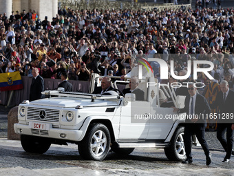 Pope Francis waves to the crowd from the popemobile as he arrives for the weekly general audience at St. Peter's Square in The Vatican on Oc...