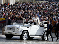 Pope Francis waves to the crowd from the popemobile as he arrives for the weekly general audience at St. Peter's Square in The Vatican on Oc...