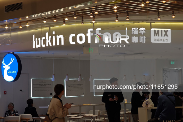 Customers shop at Luckin Coffee x Tea Mix store in Shanghai, China, on October 9, 2024. 