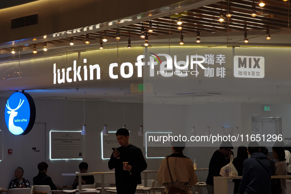 Customers shop at Luckin Coffee x Tea Mix store in Shanghai, China, on October 9, 2024. 