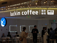 Customers shop at Luckin Coffee x Tea Mix store in Shanghai, China, on October 9, 2024. (